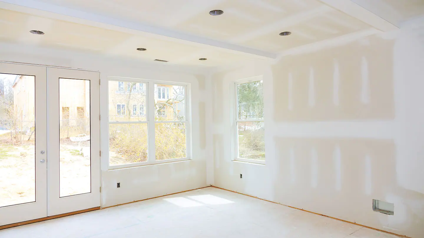 Bright interior with smooth newly finished drywall walls and ceiling